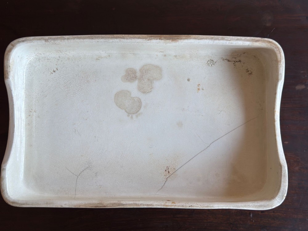 A rectangular cream ceramic grocers slab with black transfer-printed typography reading PURE BUTTER on the front edge. View VI