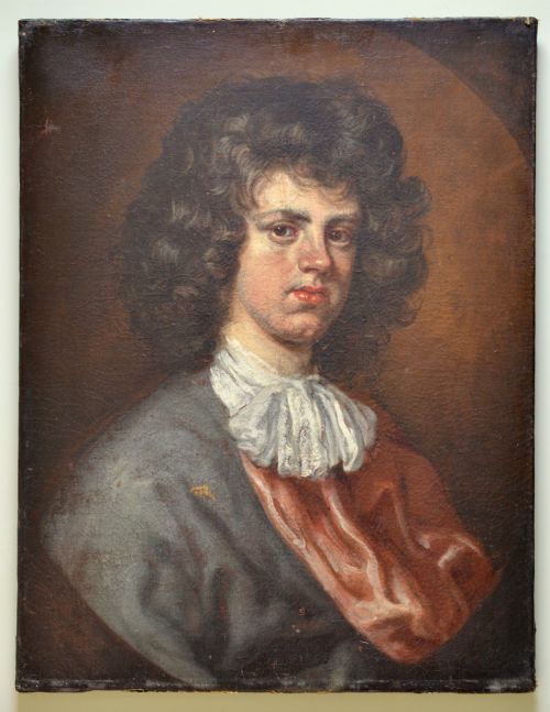fig 1. An antique oil portrait painting depicting a young gentleman with dark voluminous curls, wearing a white lace cravat and red mantle within a feigned oval frame.