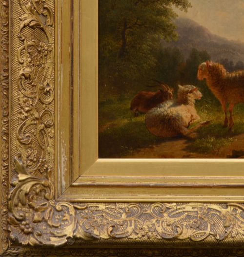 fig 1. An antique oil painting depicting sheep and a goat in a green pastoral landscape surrounded by an ornate gold giltwood frame.