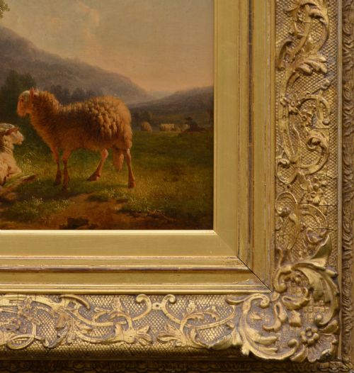 fig 2. An antique oil painting depicting sheep and a goat in a green pastoral landscape surrounded by an ornate gold giltwood frame.