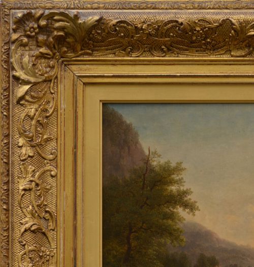 fig 3. An antique oil painting depicting sheep and a goat in a green pastoral landscape surrounded by an ornate gold giltwood frame.