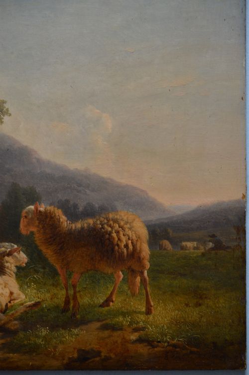 An antique oil painting depicting sheep and a goat in a green pastoral landscape surrounded by an ornate gold giltwood frame. View X