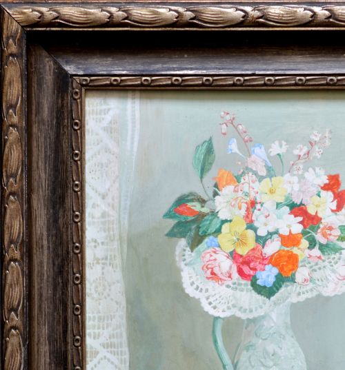 fig 1. A framed tempera painting on wood panel depicting a colourful floral bouquet in a jug beside a green glass decanter and white gloves on a teal surface.