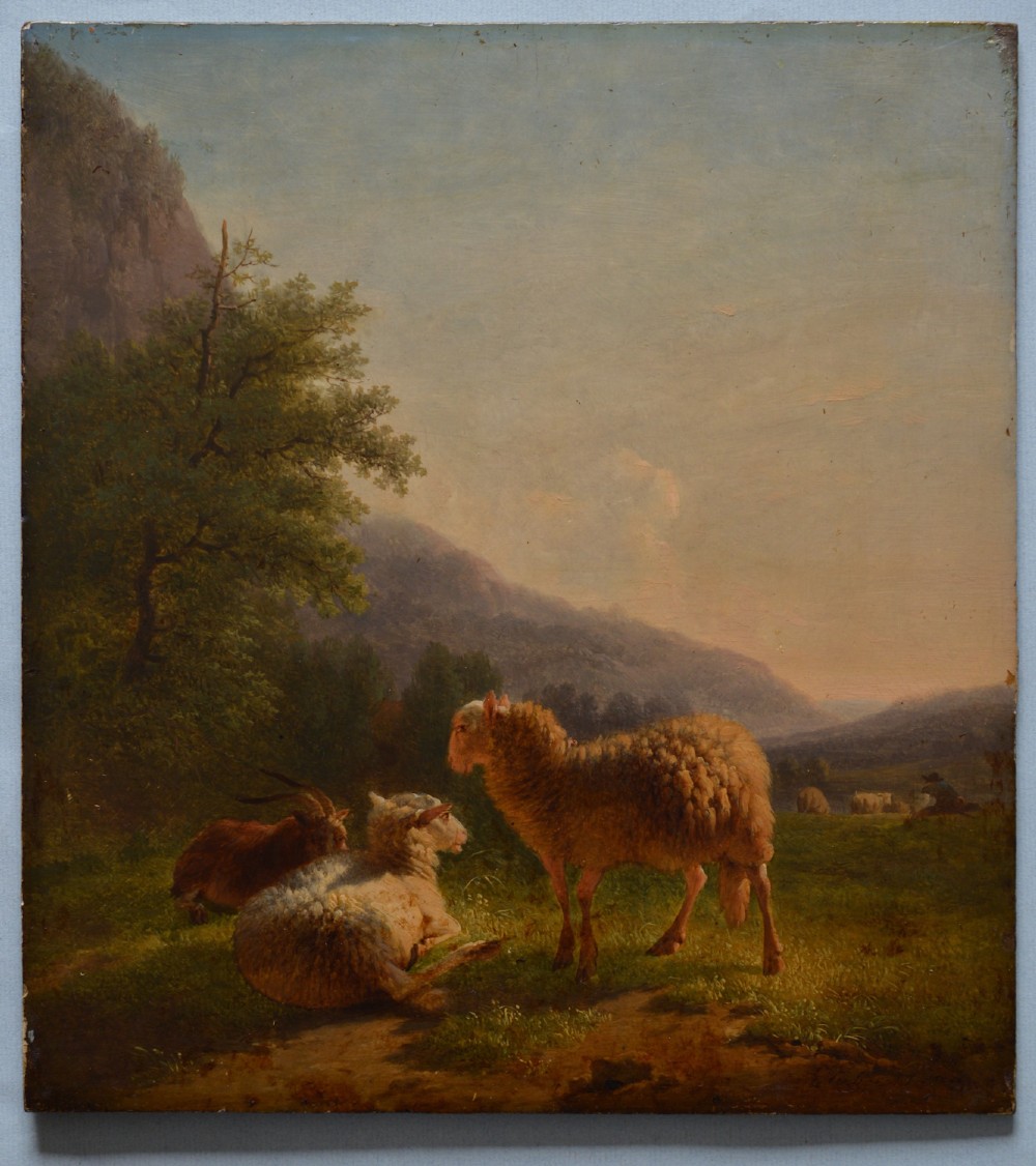 An antique oil painting depicting sheep and a goat in a green pastoral landscape surrounded by an ornate gold giltwood frame. View VI