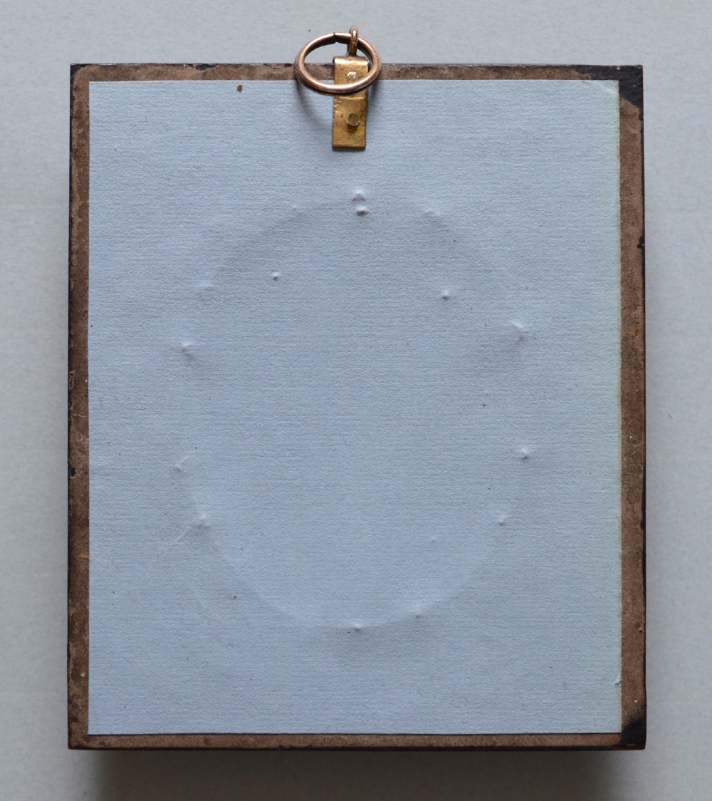 An oval late 18th-century watercolour portrait miniature depicting a gentleman wearing a blue coat and white cravat inside a metal bezel. View V