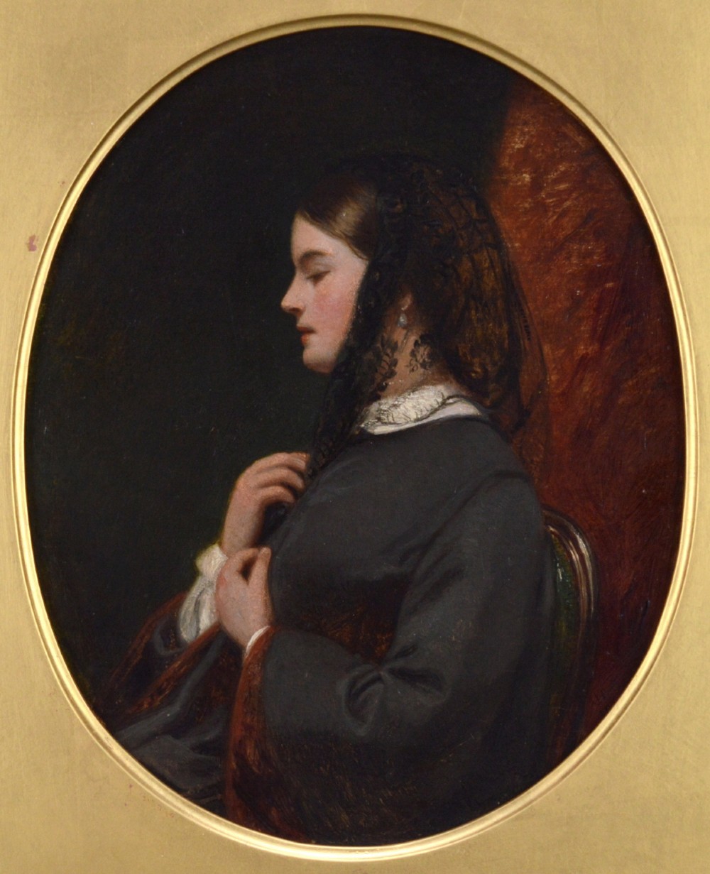 An oval Victorian oil painting depicting a woman in side profile wearing a black lace veil and dark attire, set within a gold frame.
