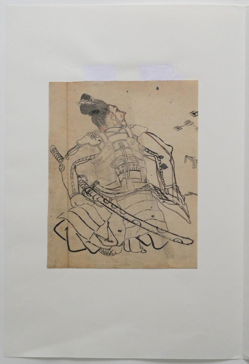 An antique Japanese ink drawing on aged paper depicting a seated samurai in detailed body armour looking upwards. View VII