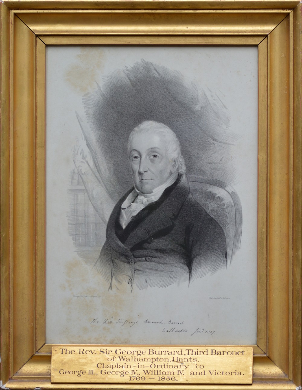 A 19th-century monochrome portrait lithograph of a gentleman in a dark coat, presented inside a moulded gilt wood frame with an inscribed metal plaque.