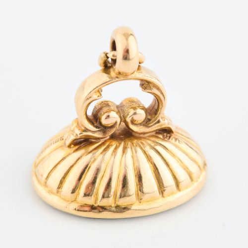 fig 1. An antique 9ct gold fob mount holding a polished oval green bloodstone with red flecks, featuring fluted rim detail and an arched suspension bail.