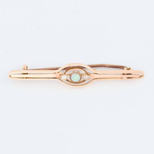 fig 1. A 9ct gold bar brooch featuring a central cabochon opal flanked by two small seed pearls within an openwork oval motif.