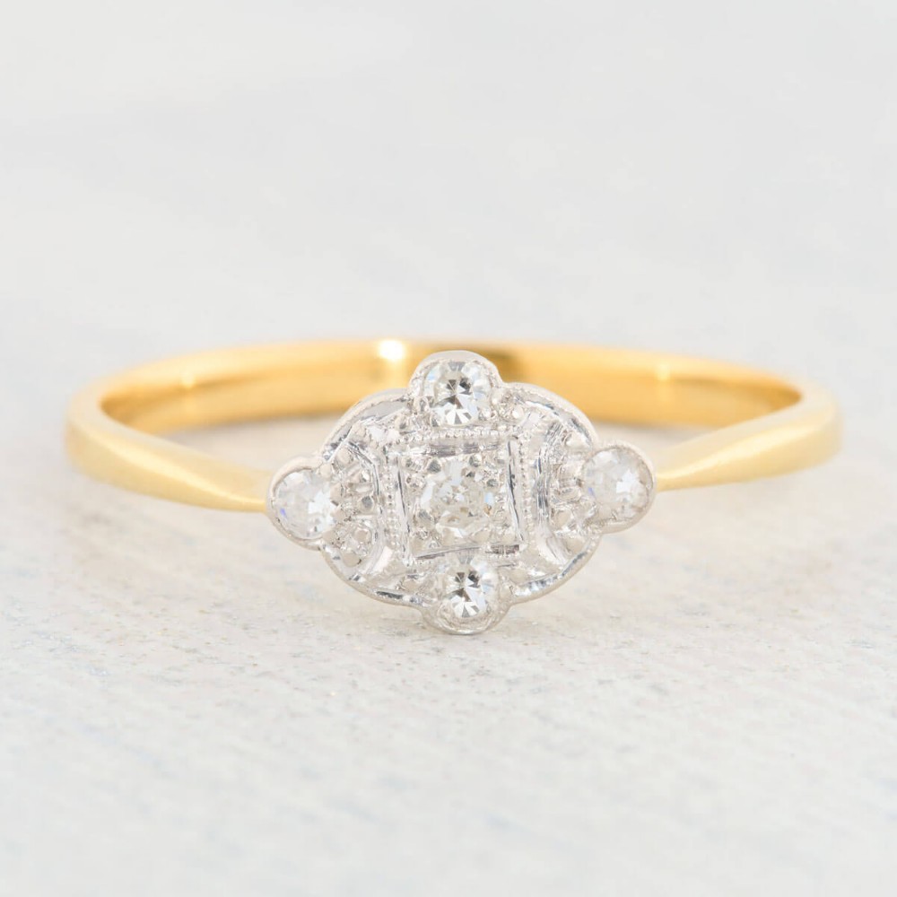 An 18ct yellow gold band featuring an Art Deco style geometric plaque set with diamonds and trimmed with millegrain edging. View III