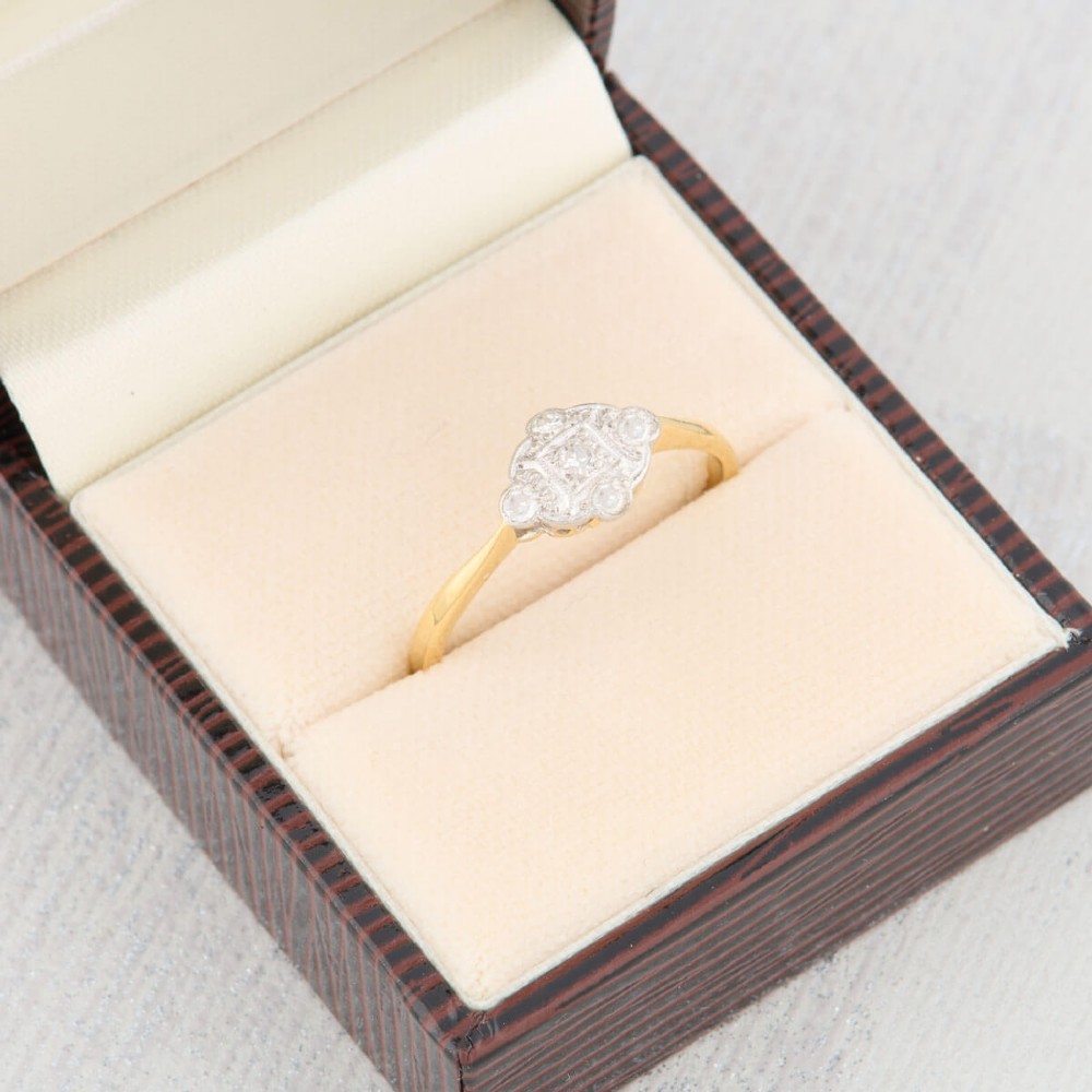 An 18ct yellow gold band featuring an Art Deco style geometric plaque set with diamonds and trimmed with millegrain edging. View VII