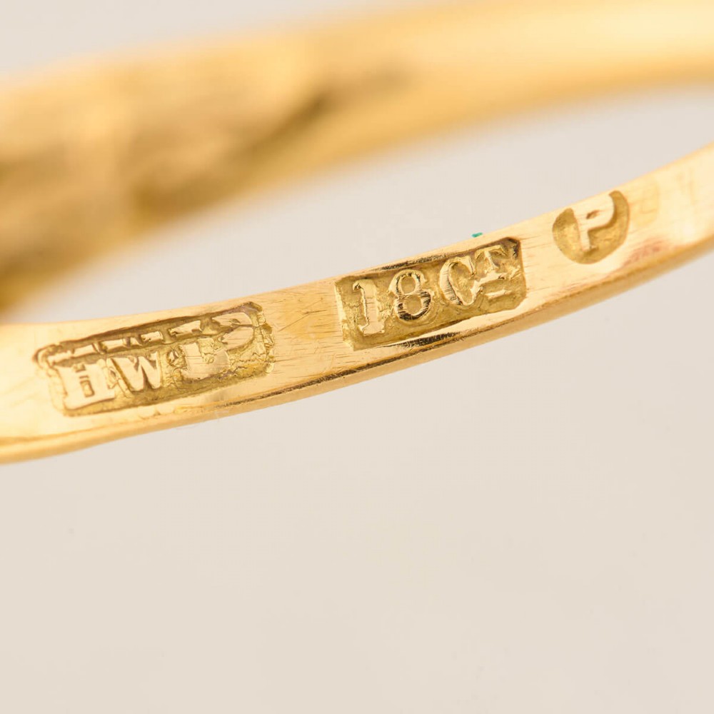 An antique 18ct yellow gold ring featuring five graduated round cut diamonds set in a carved gold gallery. View VIII