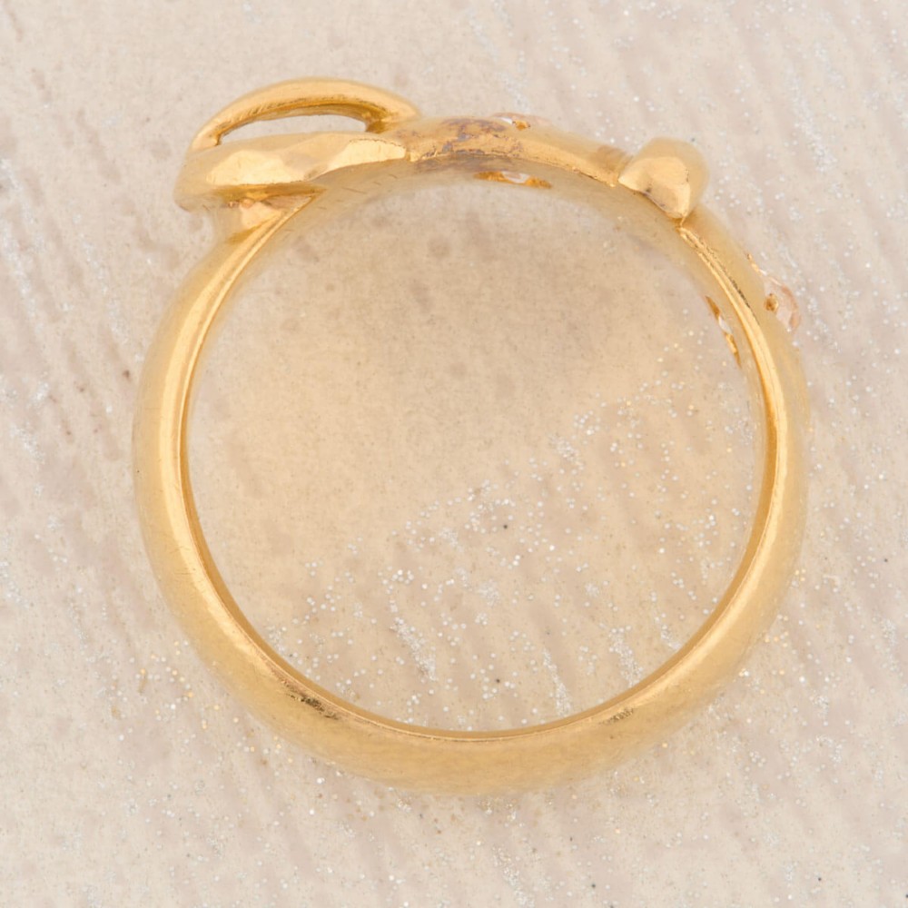 An 18ct yellow gold band shaped as a belt buckle with two star-set diamond accents. View VII