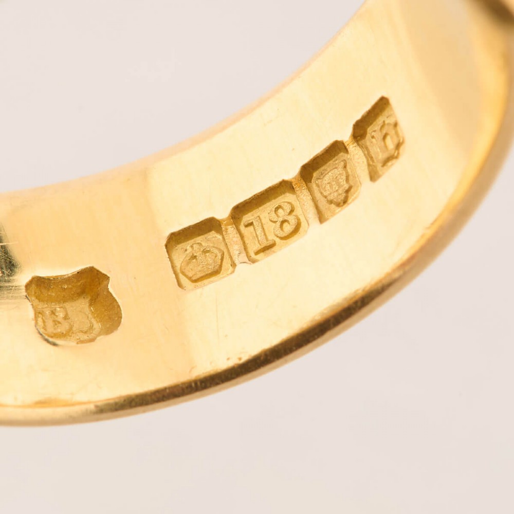 An 18ct yellow gold band shaped as a belt buckle with two star-set diamond accents. View VIII