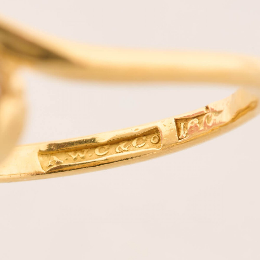 An 18ct yellow gold crossover bypass ring featuring two claw-set round brilliant diamonds. View VII