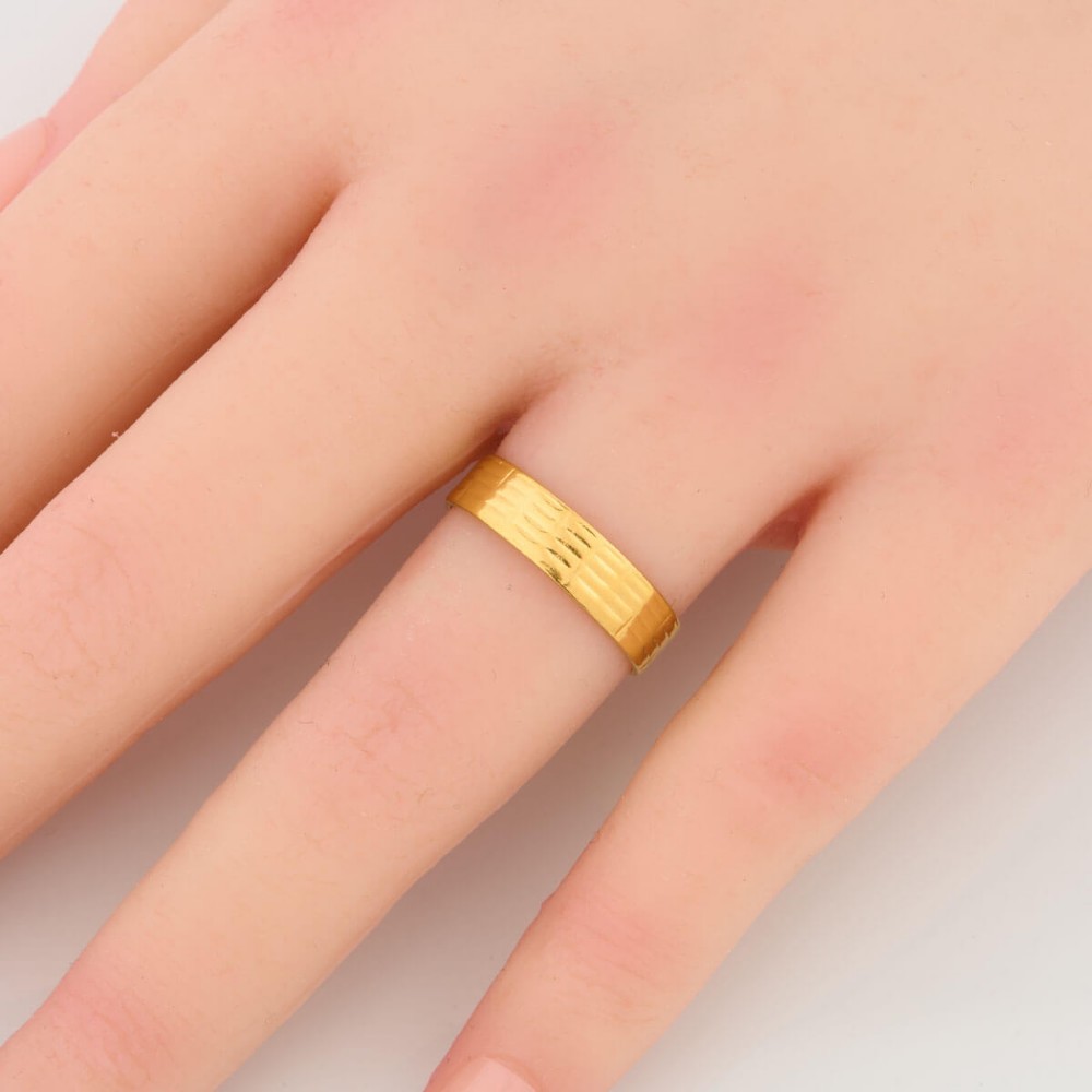 A wide 22ct yellow gold wedding ring featuring an engraved ribbed geometric pattern along the exterior surface and internal hallmarks. View II