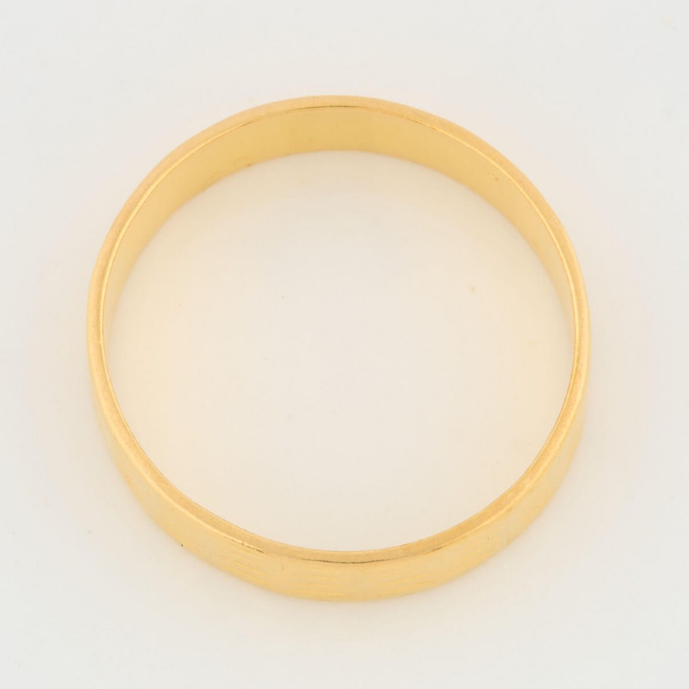 A wide 22ct yellow gold wedding ring featuring an engraved ribbed geometric pattern along the exterior surface and internal hallmarks. View IV