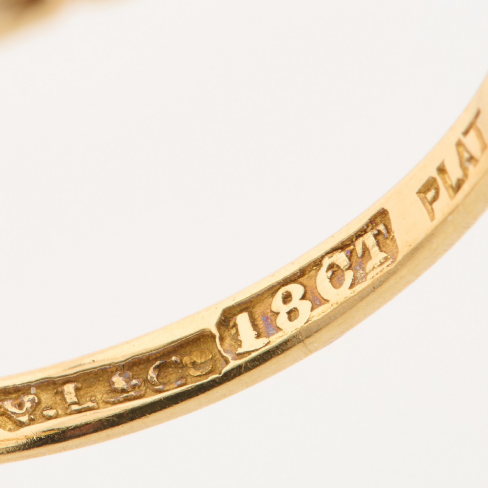 An 18ct yellow gold trilogy ring featuring three round diamonds set in platinum rub-over settings. View VII