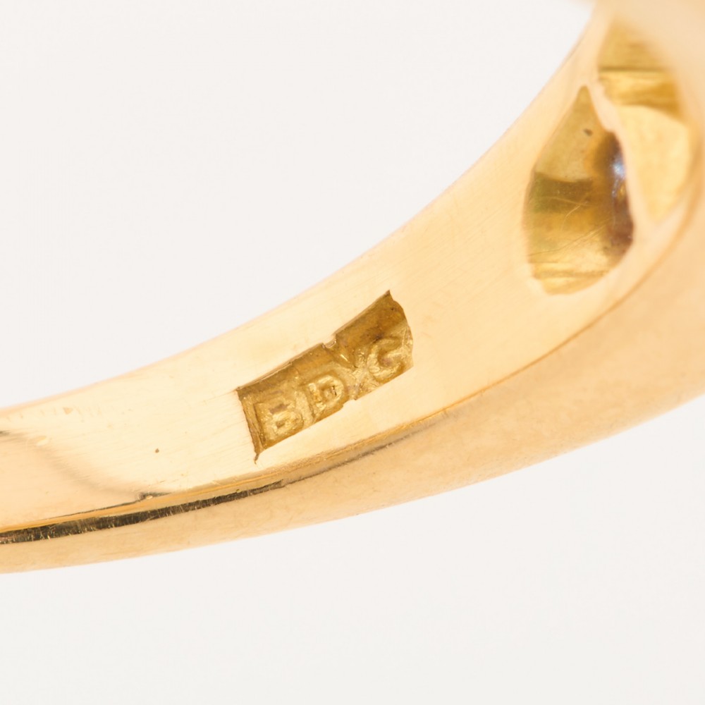 An 18ct yellow gold five-stone ring featuring three round blue sapphires alternating with two round diamonds in a carved boat-style gallery. View VII
