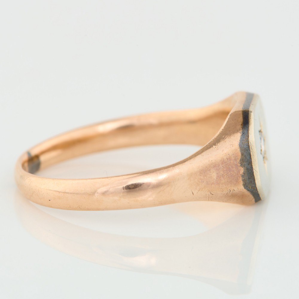 A 9ct yellow gold signet ring featuring an octagonal face with a starburst-set diamond in the centre. View III