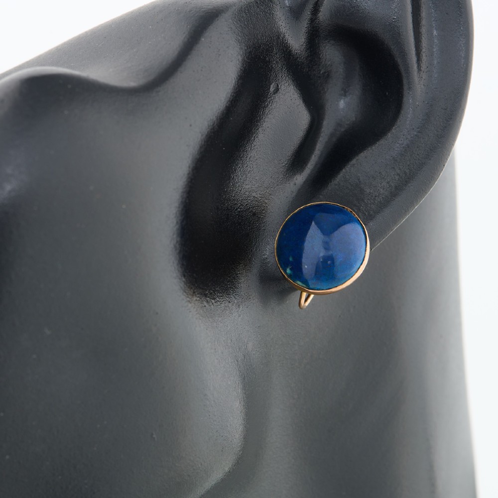 A pair of round 9ct yellow gold screw-back earrings set with polished deep blue lapis lazuli cabochon gemstones. View II
