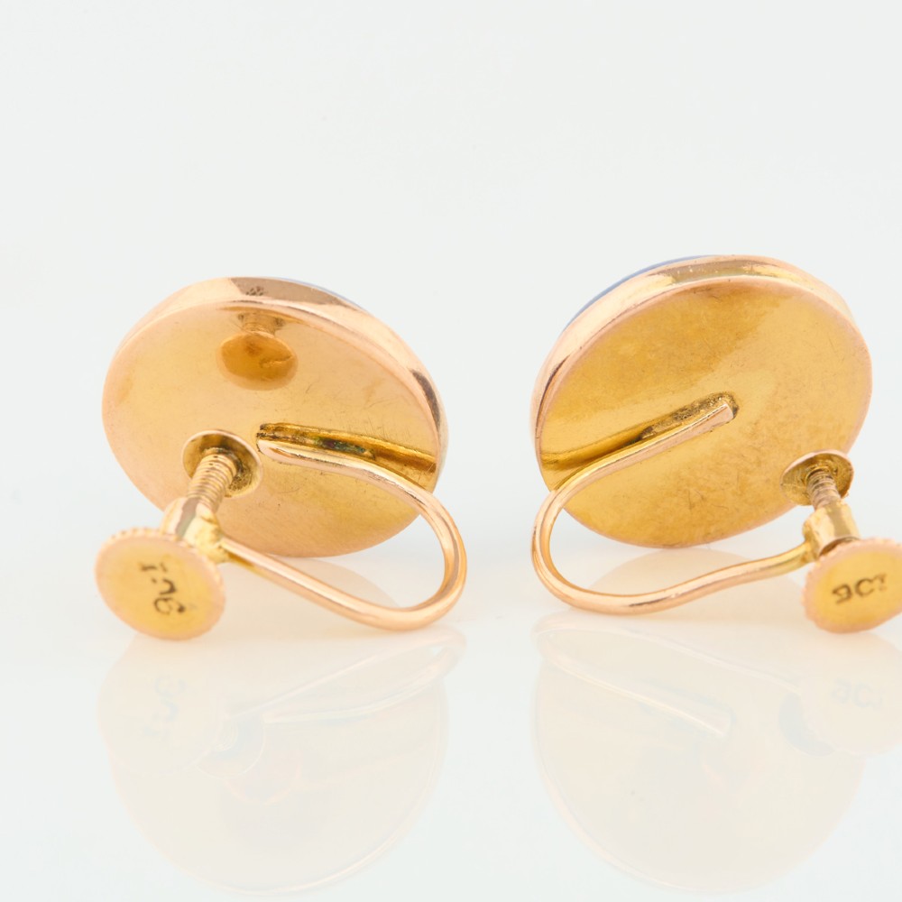 A pair of round 9ct yellow gold screw-back earrings set with polished deep blue lapis lazuli cabochon gemstones. View VI