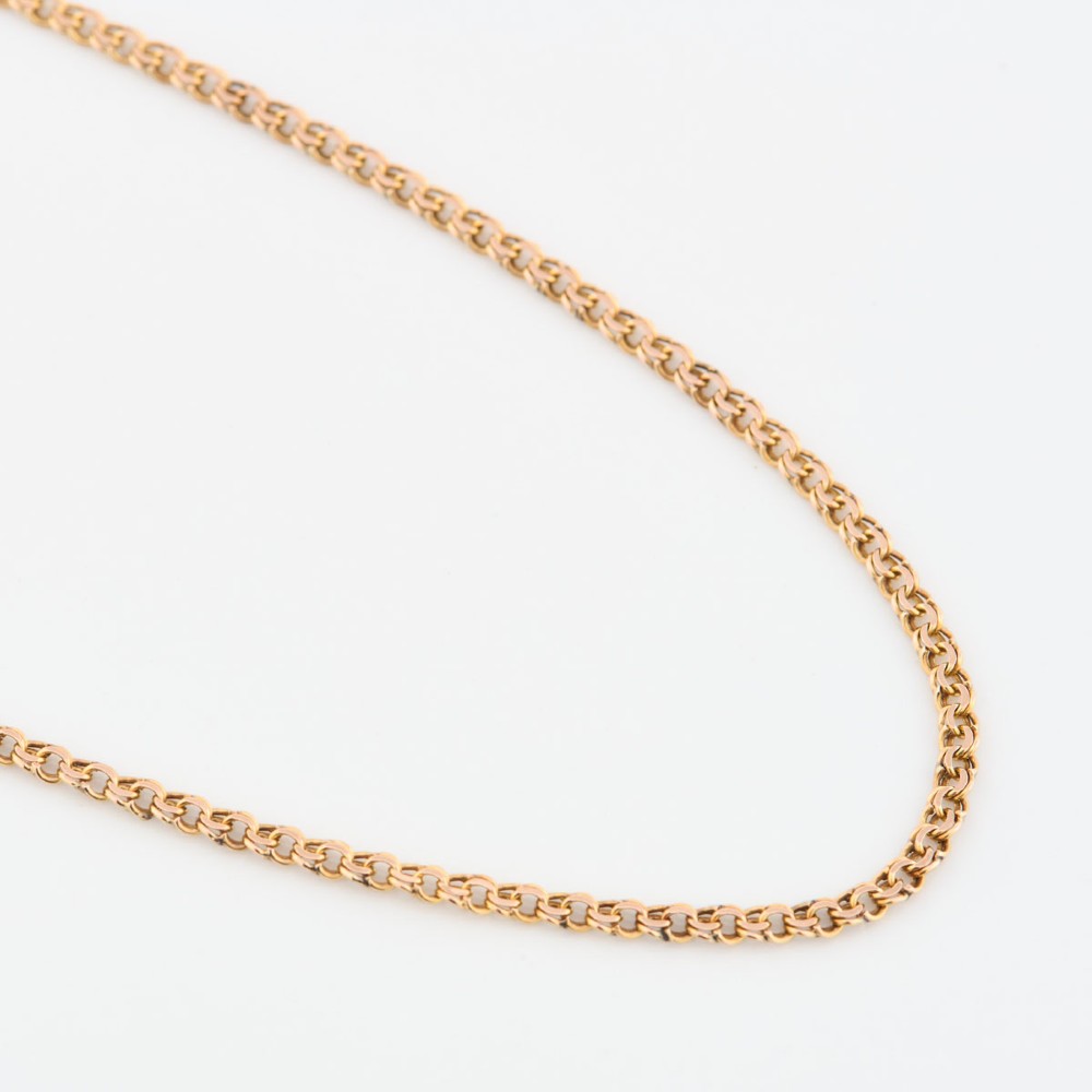 A close-up view of a 9ct gold double belcher chain necklace draped against a white background.