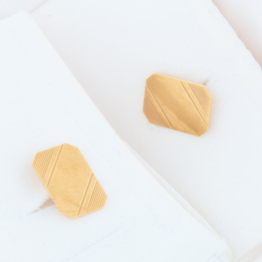 A pair of 9ct yellow gold octagonal chain cufflinks featuring engine-turned diagonal line engraving on polished panels. View II