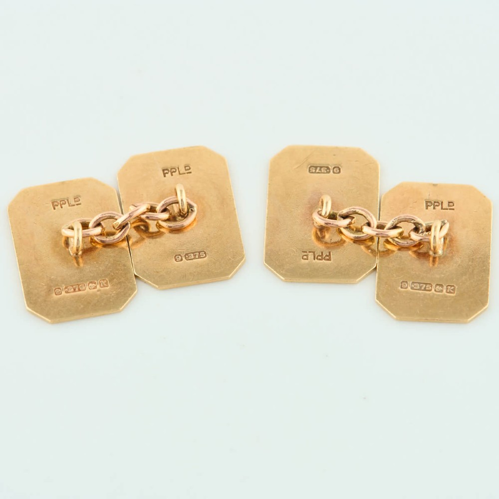 A pair of 9ct yellow gold octagonal chain cufflinks featuring engine-turned diagonal line engraving on polished panels. View V