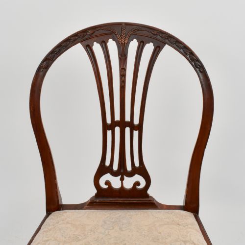 fig 2. An 18th-century mahogany dining chair featuring an arched back with carved splat, square legs, structural stretchers, and a patterned cloth seat.