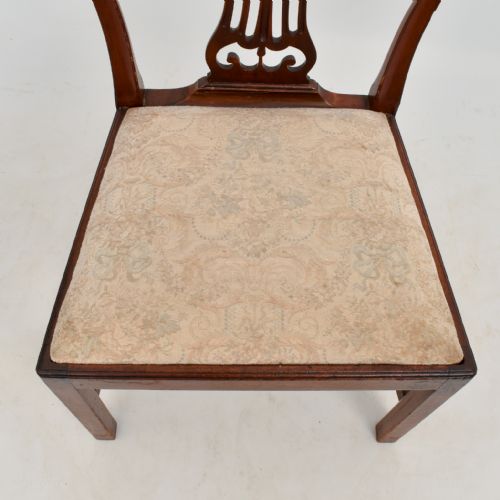 fig 3. An 18th-century mahogany dining chair featuring an arched back with carved splat, square legs, structural stretchers, and a patterned cloth seat.