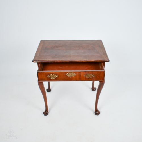 fig 2. A George III walnut side table with cabriole legs, pad feet, a single drawer with brass escutcheons, and a shaped apron.