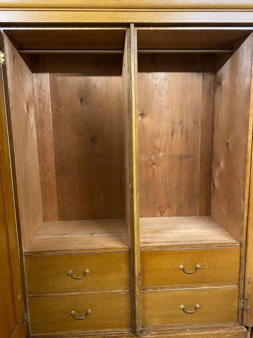fig 2. A 19th-century two-door wooden wardrobe featuring scumble faux oak paintwork, a moulded top cornice, double panelled doors, and a solid plinth base.
