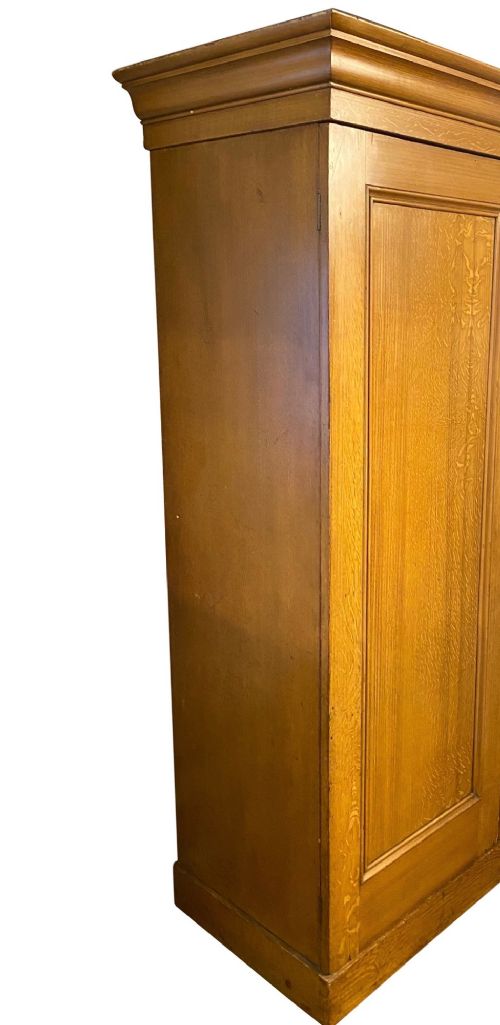 A 19th-century two-door wooden wardrobe featuring scumble faux oak paintwork, a moulded top cornice, double panelled doors, and a solid plinth base. View VII