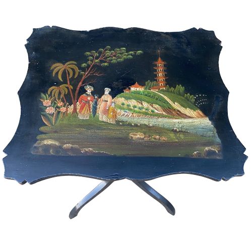 fig 2. A black lacquered tripod side table featuring a shaped top decorated with a hand-painted Chinoiserie landscape scene resting on a turned column pedestal.