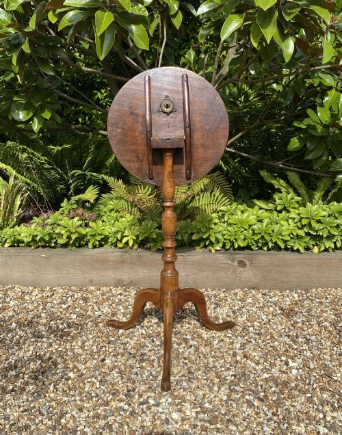 fig 1. An 18th-century George II walnut wine table featuring a circular top, a baluster-turned central column, and a three-legged tripod base.
