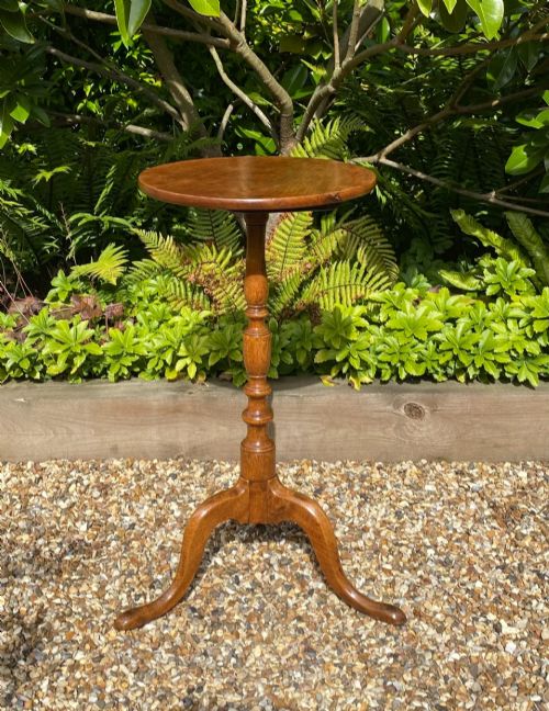 fig 2. An 18th-century George II walnut wine table featuring a circular top, a baluster-turned central column, and a three-legged tripod base.