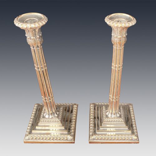 fig 1. A pair of Georgian silver-plated candlesticks featuring fluted column stems and tiered square bases with beaded borders.