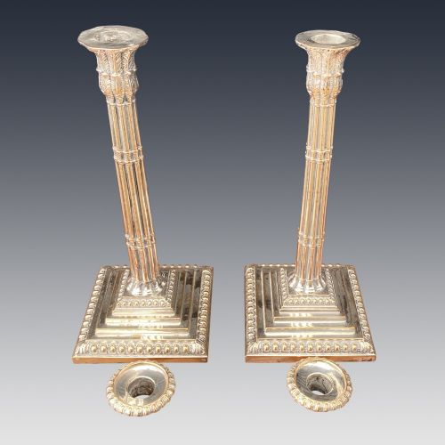 fig 2. A pair of Georgian silver-plated candlesticks featuring fluted column stems and tiered square bases with beaded borders.