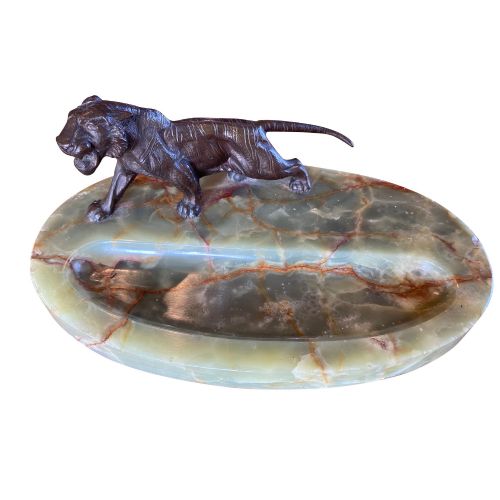 fig 1. An Art Deco green onyx oval tray featuring a central recessed groove for pens and a dark bronze tiger figure mounted on the rim.