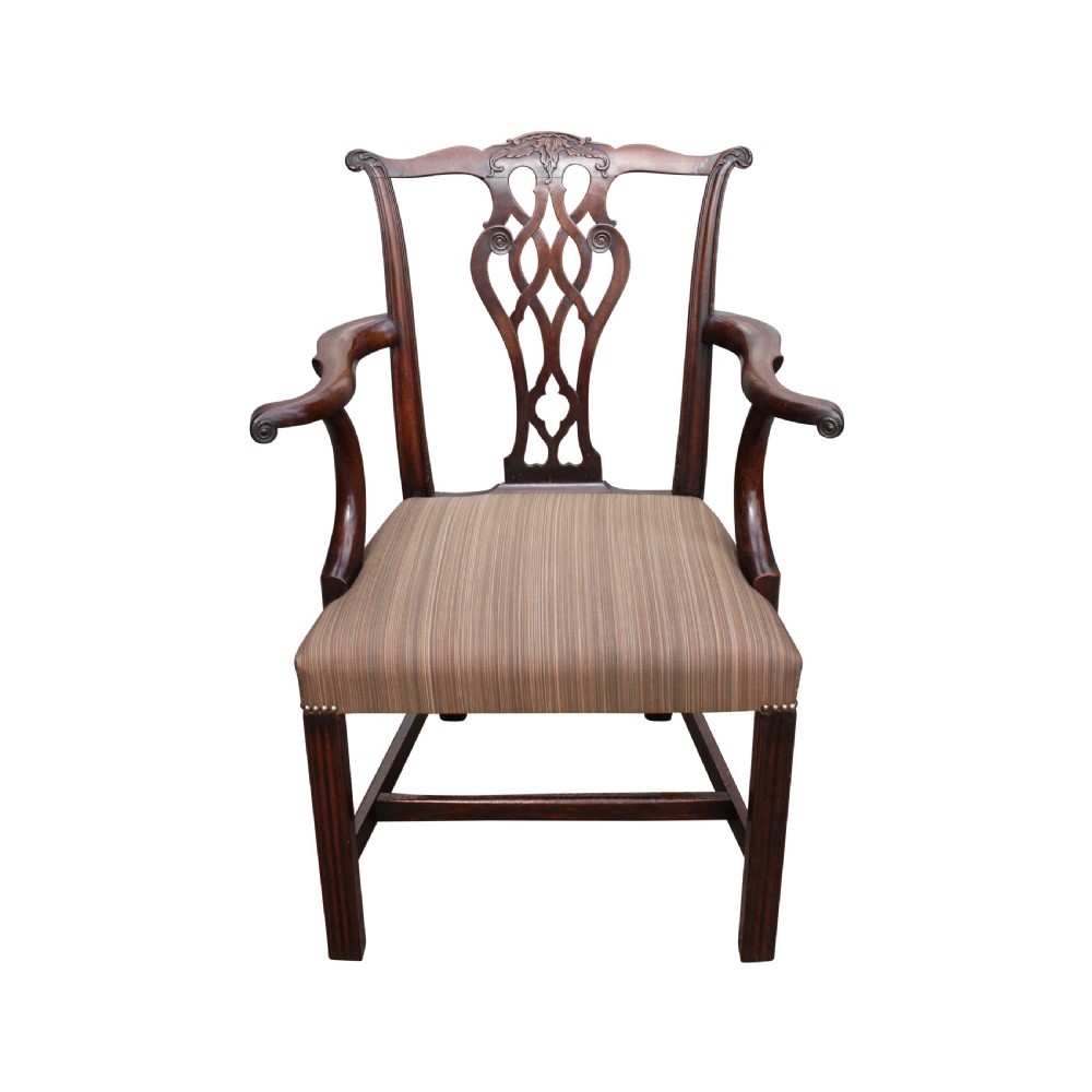An antique dark mahogany Georgian Chippendale armchair featuring an interlaced pierced splat back, scrolled arms, and a striped upholstered drop-in seat. View II