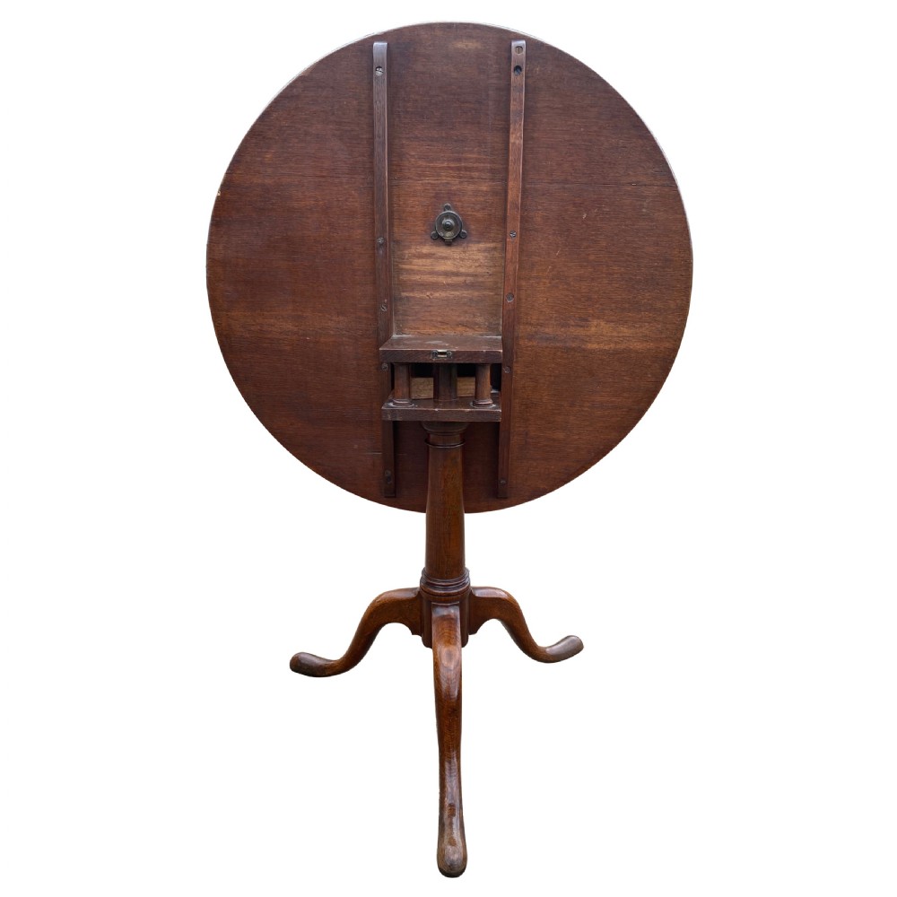 An antique Georgian circular oak tripod table with a central pillar and three curving cabriole legs. View III
