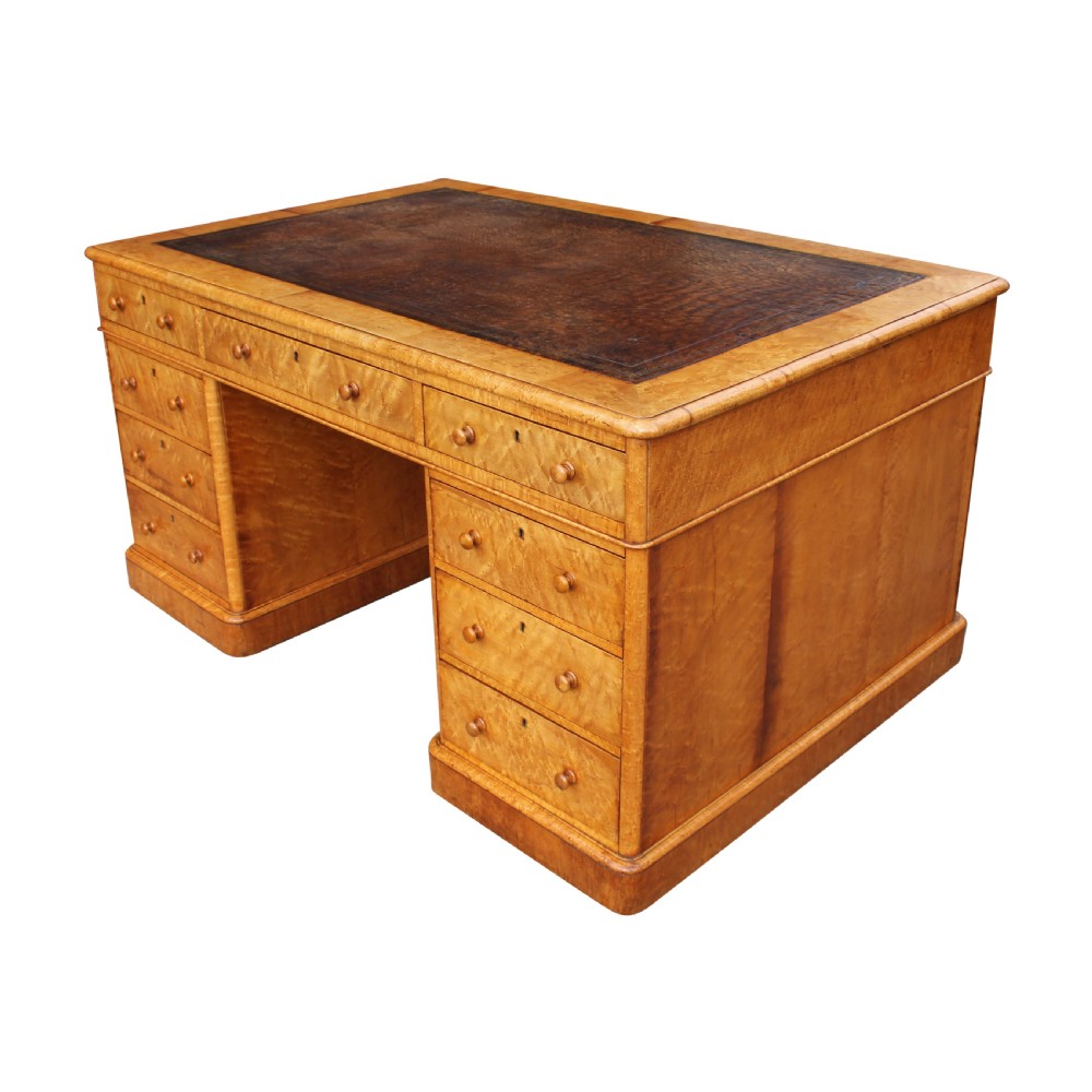 A nineteenth-century birds eye maple partners desk featuring a dark leather inset top and multiple pedestals of drawers with wooden knobs. View II