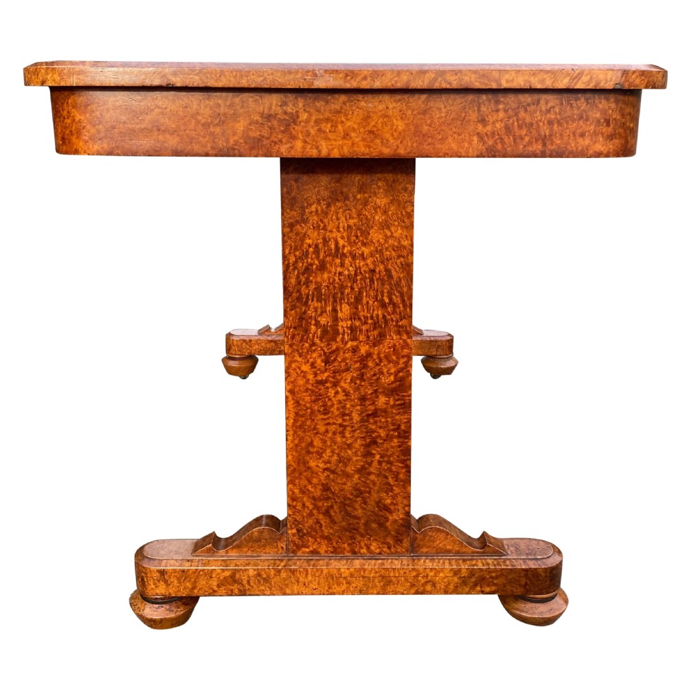 A nineteenth-century rectangular amboyna writing table featuring a brown leather inset top and dual trestle supports. View III