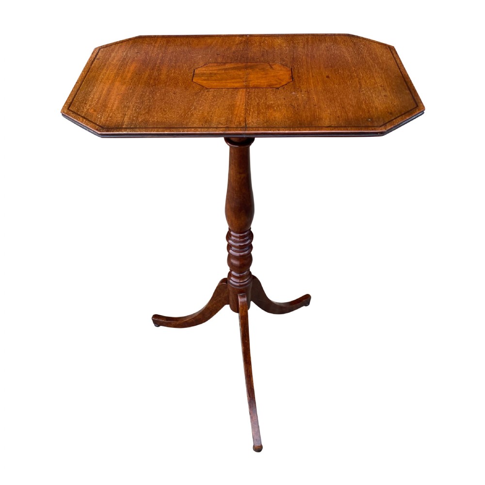 A 19th-century mahogany and cherry wood wine table featuring an octagonal top with central inlay, a turned pedestal column, and a tripod base.