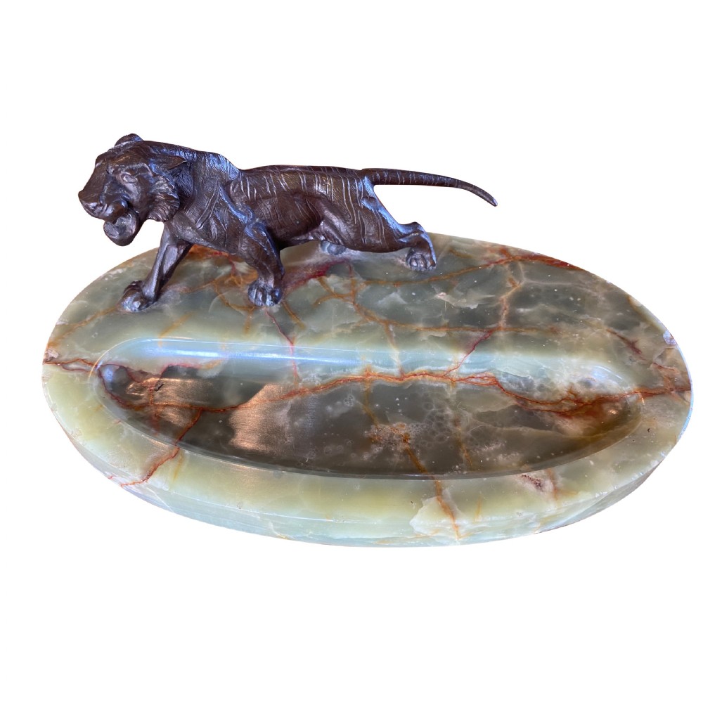 A cast bronze tiger sculpture mounted on an oval green and brown veined onyx base with a recessed pen tray.