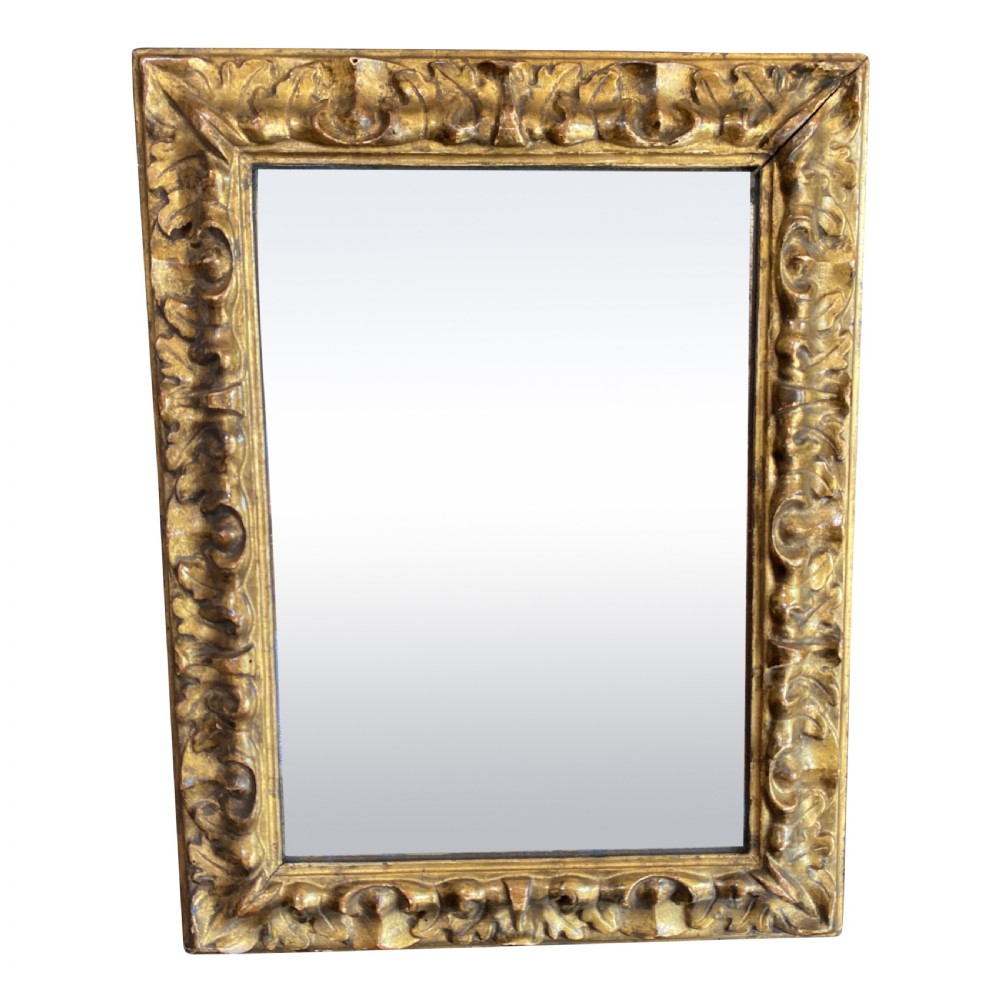 A rectangular George III period wall mirror in a carved giltwood frame with acanthus leaf motifs.