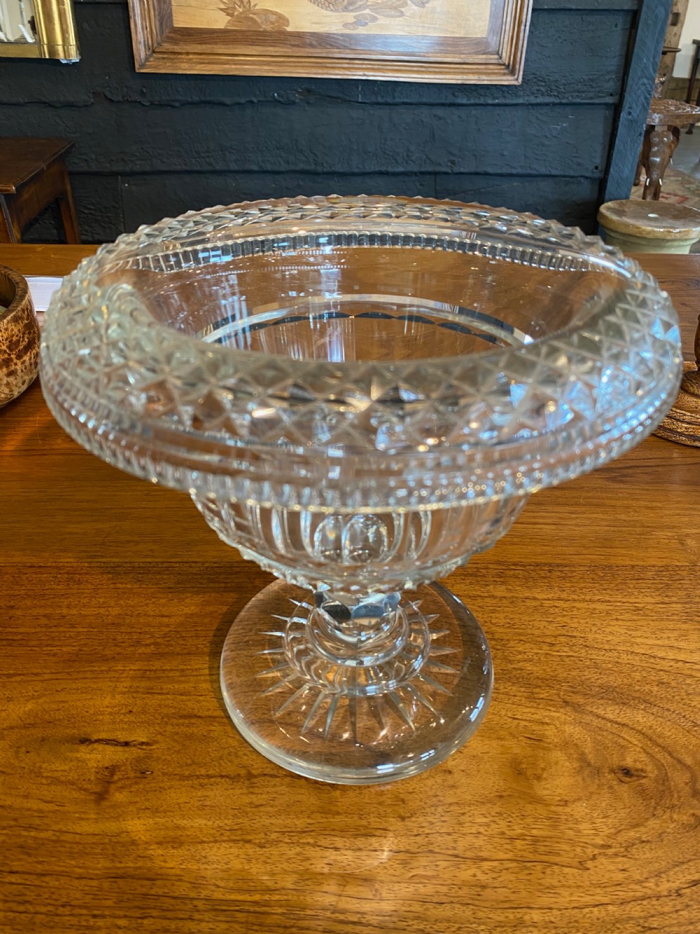 A nineteenth-century clear cut crystal pedestal bowl with diamond geometric cutting and a starburst faceted circular base. View II
