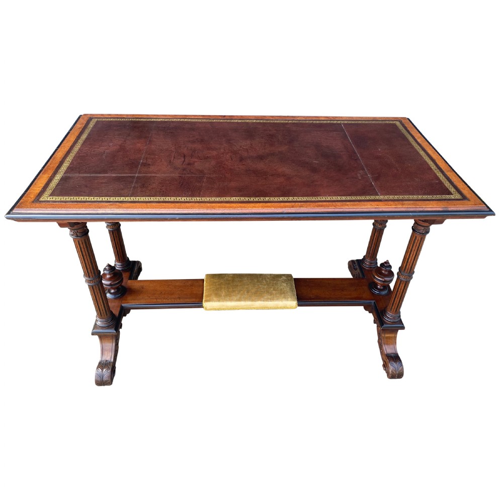 Late nineteenth-century mahogany writing table featuring a dark brown leather inset top with gilded tooling, fluted legs, and a central velvet-padded footrest on a low stretcher. View II